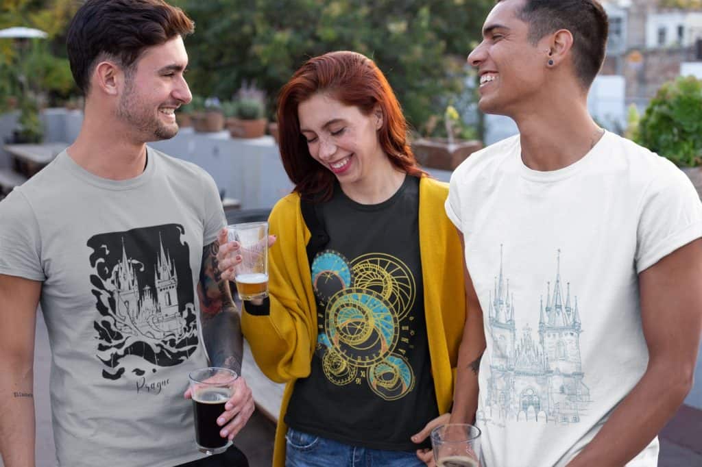 Demonstrative picture of models wearing souvenir t-shirts from prague local artists.